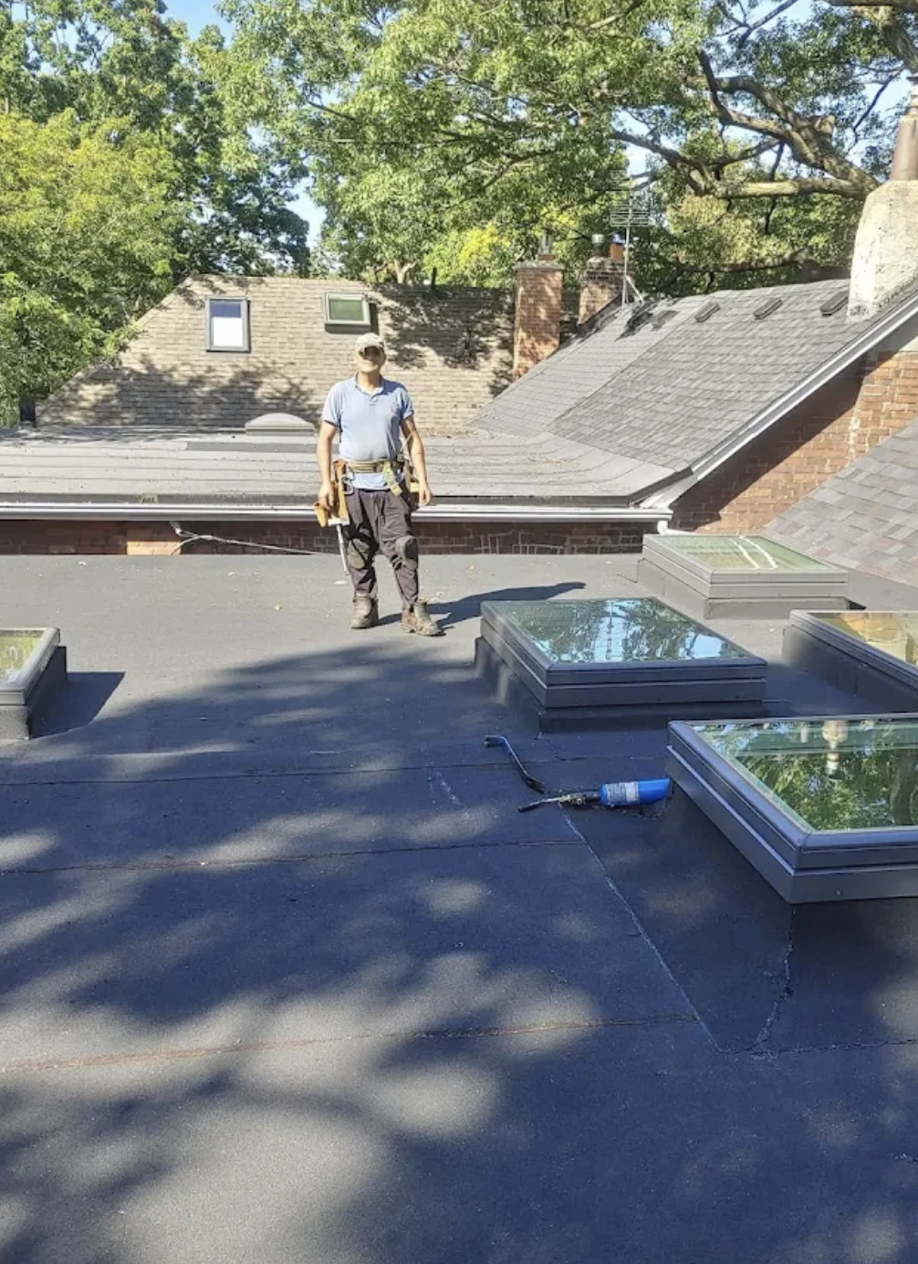 Ali on a finished flat roof with newly installed skylights